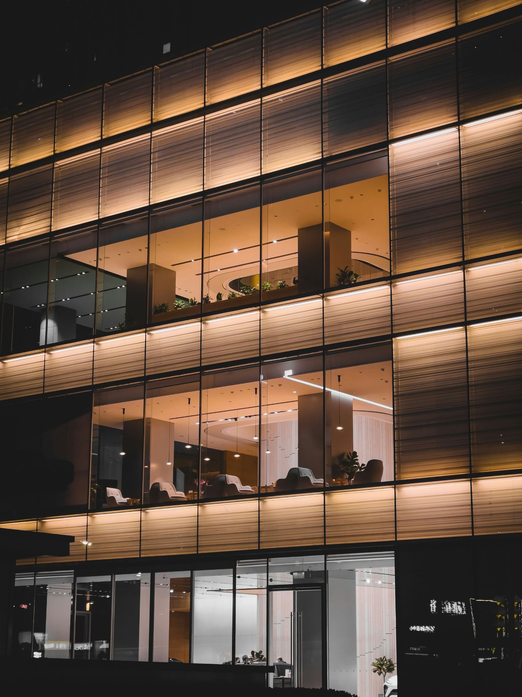 Warmly lit office building at dusk